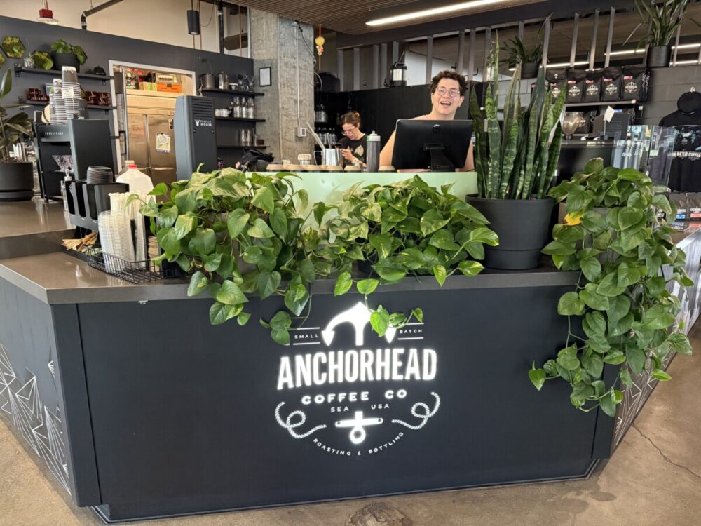 A Seattle Food Itinerary: 2 Days of Pike Place Market, Seafood, and Wine 18 man standing behind the counter at Anchorhead Coffee