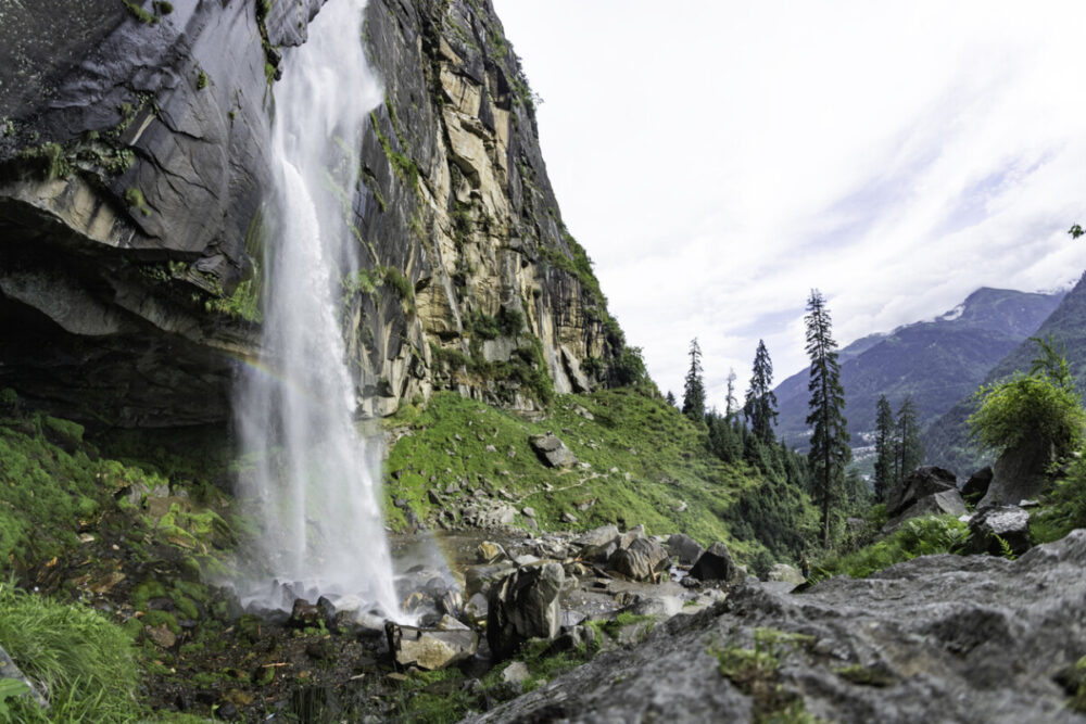 Delhi to Manali Bus Guide: Route, Views, and Travel Tips 1 Jogini Waterfall surrounded by cedar forrest in the Himalayas. On the bus route from Delhi to Manali.
