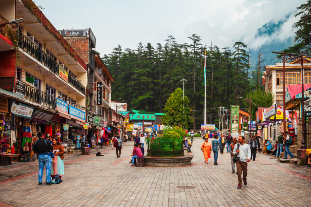 Delhi to Manali Bus Guide: Route, Views, and Travel Tips 2 A wide brick paved pedestrian street in Manali. The destination of the Delhi to Manali bus.