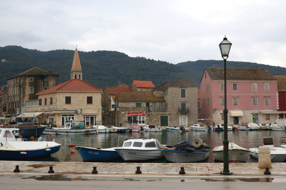 Best Time to Visit Hvar: A Seasonal Guide to Planning Your Trip 3 Fishing boats and traditional architecture in Stari Grad, small town on island Hvar, Croatia on a rainy December day