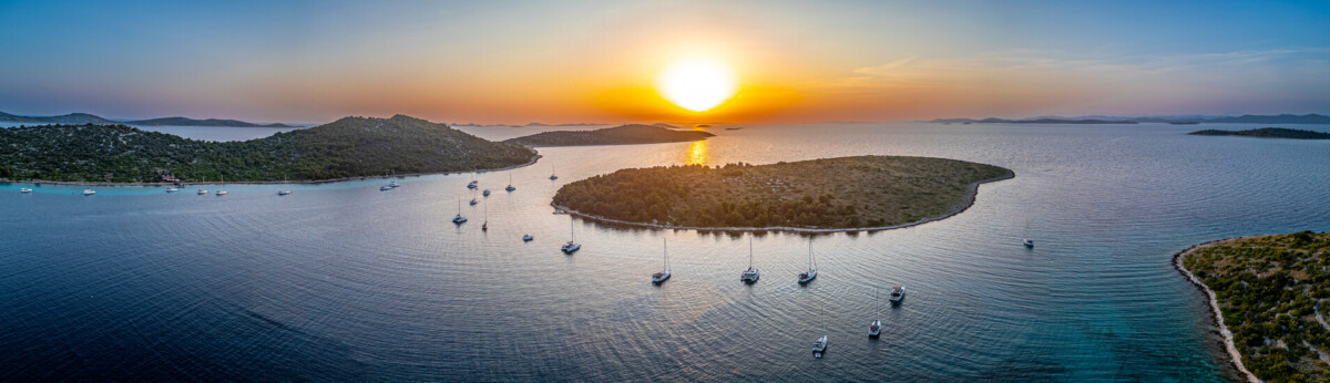 Beautiful shot of islands with small ship cruising in croatia in the Adriatic Sea