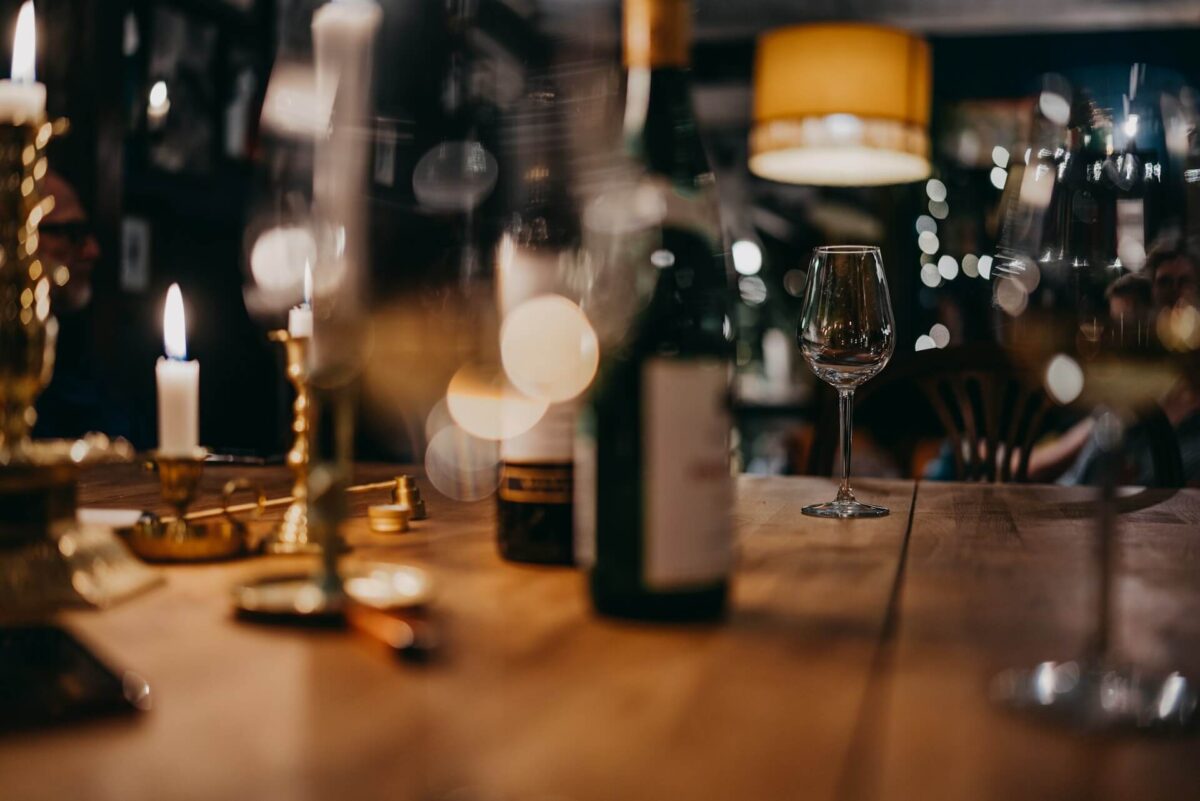 wine bottle on brown wooden restaurant table