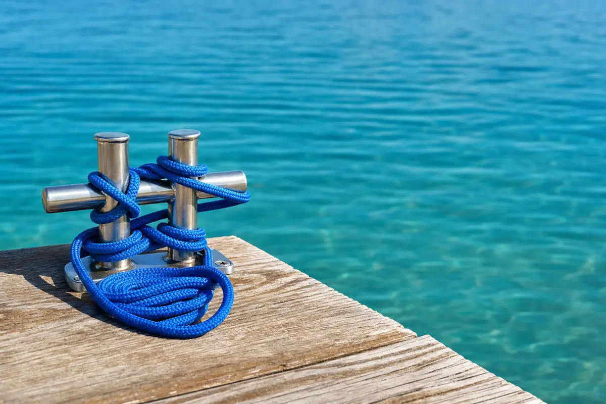 How to Choose the Right Boat for Your Water Adventures 1 Wooden boat dock with a blue rope tied to a cleat.
