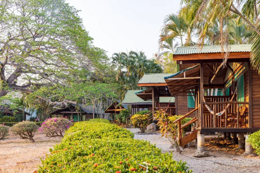 How to Choose a Birding Lodge in Costa Rica 1 Cabins around a garden of an birding lodge in Costa Rica.