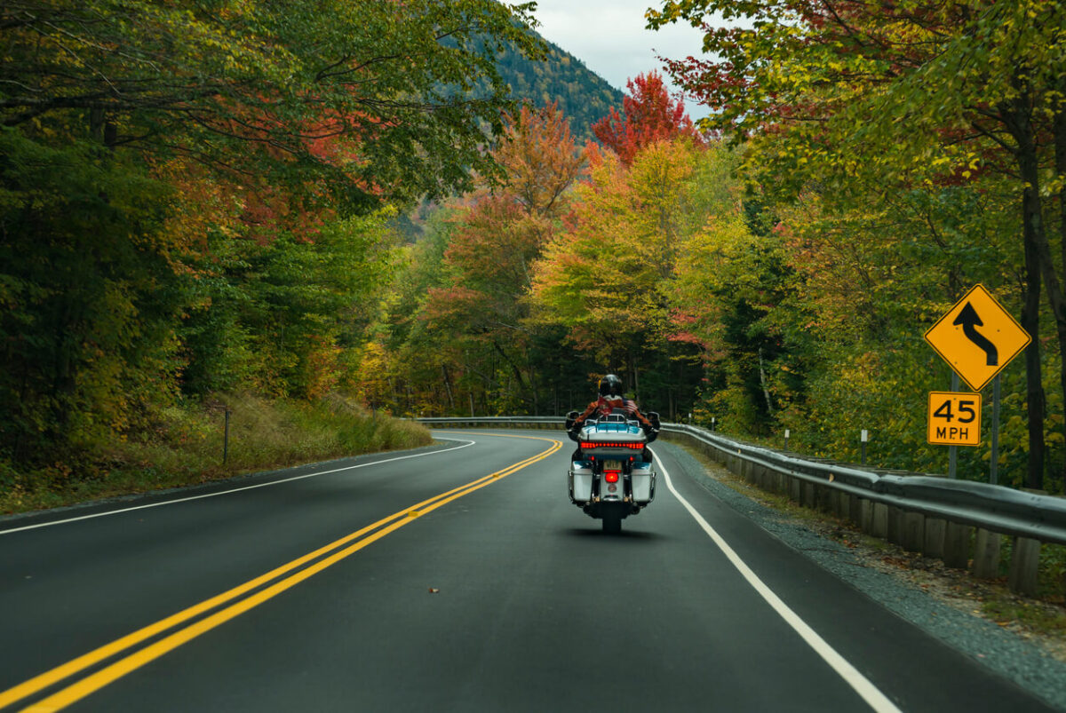 Motorcycle driving on the road on the White Mountains during the fall, New Hampshire, USA
