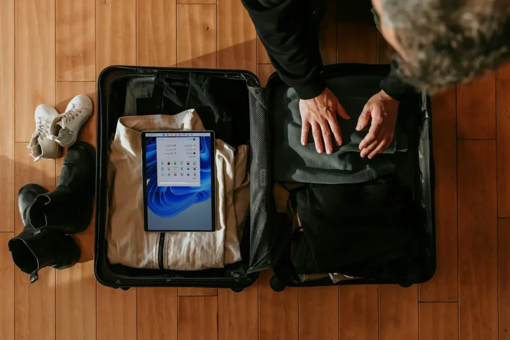 How to Build a Travel Capsule Wardrobe With an AI Stylist 1 An overhead view of a person packing a suitcase
