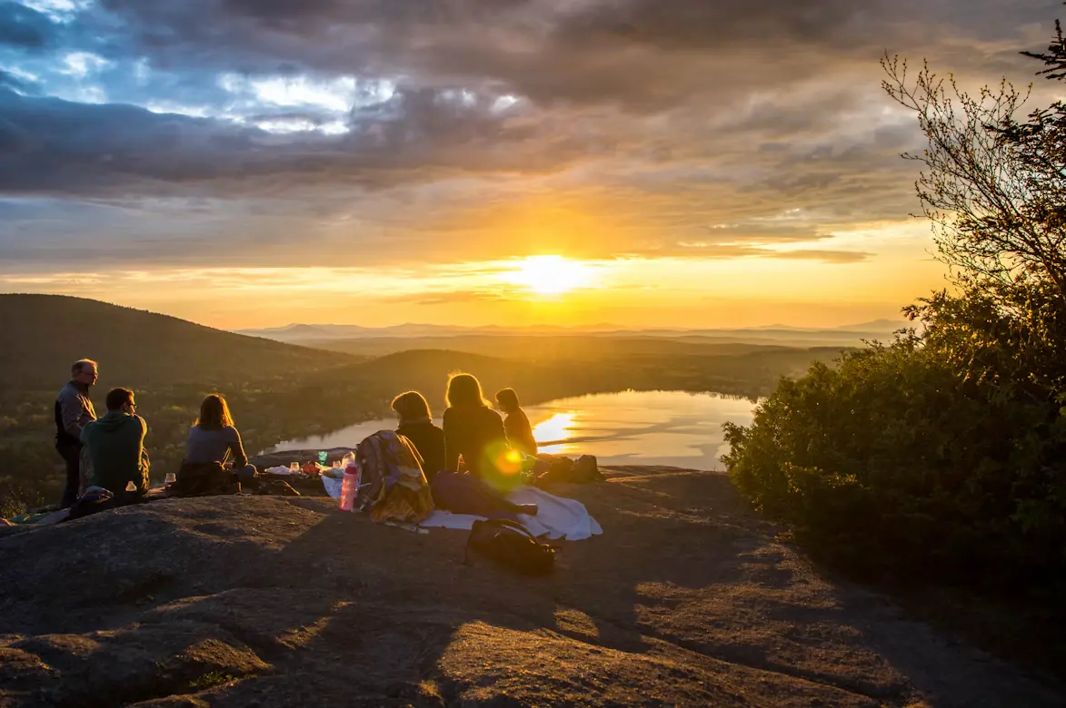 Family Road Trip Food: What to Make and Pack Before You Go 1 family enjoying a picnic at sunset
